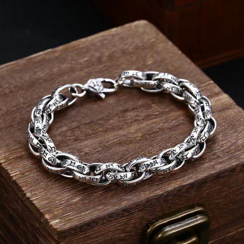Tibetan Om Mani Padme Hum Copper Bracelet – carved silver links on antique wooden chest, vintage jewelry Hauptbild