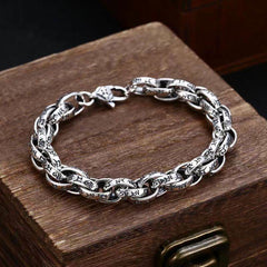 Tibetan Om Mani Padme Hum Copper Bracelet – carved silver links on antique wooden chest, vintage jewelry