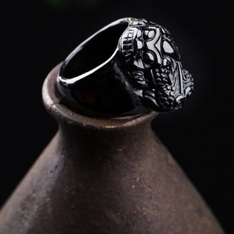 FengShui PiXiu Strength Ring – Dark skull-carved obsidian ring on rustic ceramic pot, statement jewelry