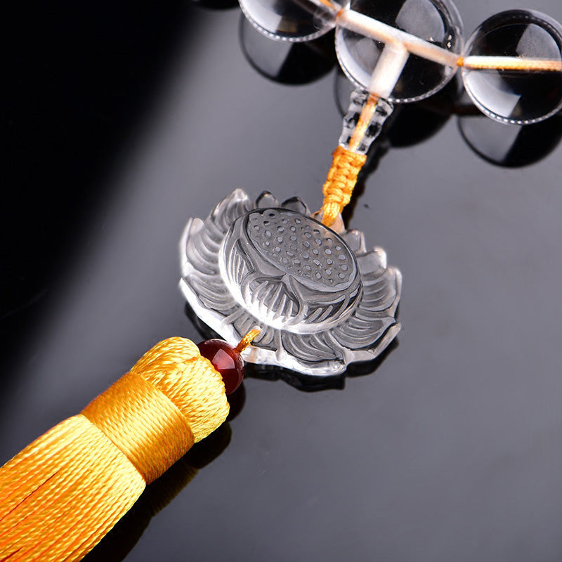 White Crystal Lotus Mala – close-up carved crystal lotus pendant with golden tassel and braided cord, zen decor