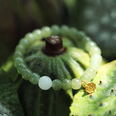 Jade Lotus Abundance Bracelet – Celadon jade beads with gold lotus pod charm on lotus seed pod, jade bracelet