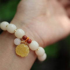 Gradient Bodhi Seed Amber Lotus Bracelet – carved amber flower on wrist with red agate accents, Calm