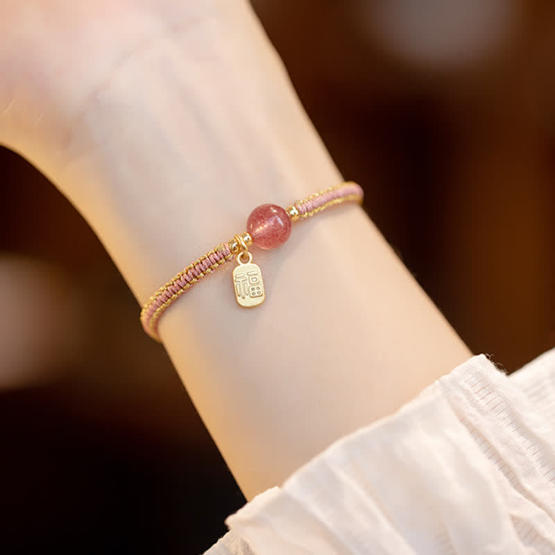 Red Agate Jade Lotus Bracelet – pink gold braided cord with pink quartz bead and rectangular Fu charm, lifestyle wrist shot