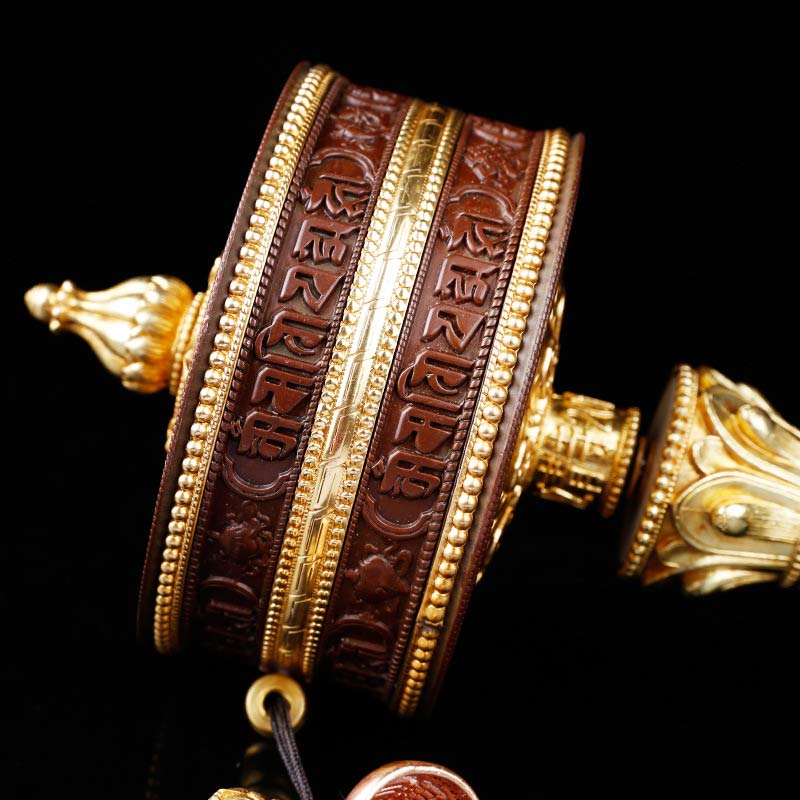 Copper Prayer Wheel – Angled view showing embossed mantra bands and brass fittings, spiritual healing