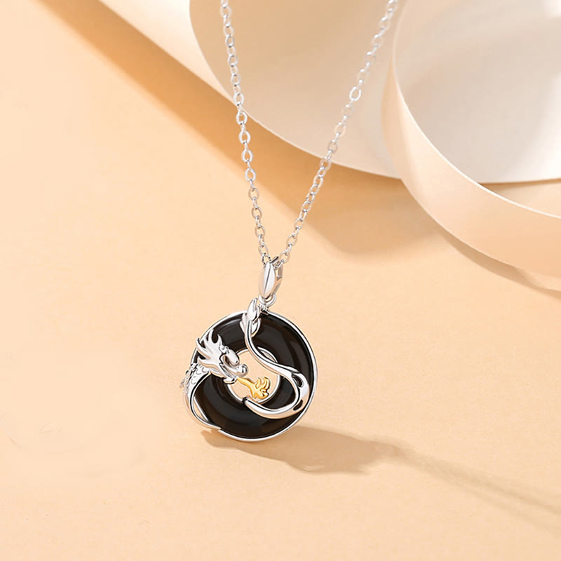 Black Onyx Dragon Phoenix Pendant - silver dragon coiled around black onyx disc with gold pearl, Strength