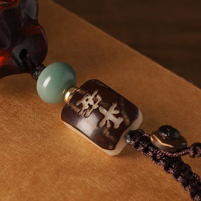 Sandalwood Money Bag Mantra Hanging - Close-up of carved Ping An bead, sandalwood charm