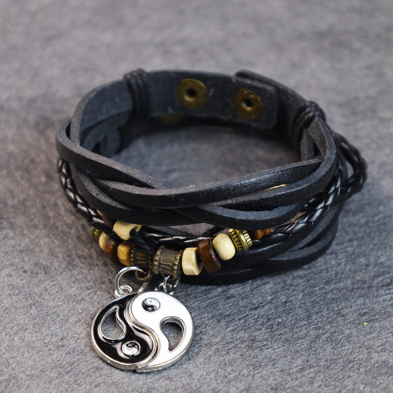 Copper Yin Yang Balance Bracelet - Layered leather wrap bracelet with yin-yang charm on stone surface