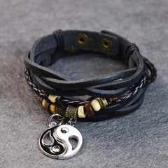 Copper Yin Yang Balance Bracelet - Layered leather wrap bracelet with yin-yang charm on stone surface