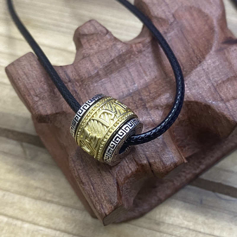 Tibetan Om Mani Padme Hum Pendant - Gold-tone pendant with arrow motifs on black cord on carved wood, men charm