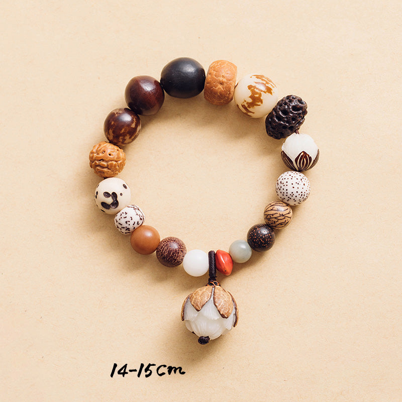 Bodhi Seed Lotus Bracelet – Flat lay showing lotus pendant and carved Buddha bead, 18-seed mala