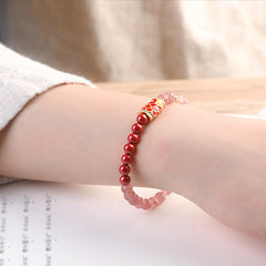 Strawberry Quartz Koi Bracelet – pair of quartz beads showing color variation and internal clarity