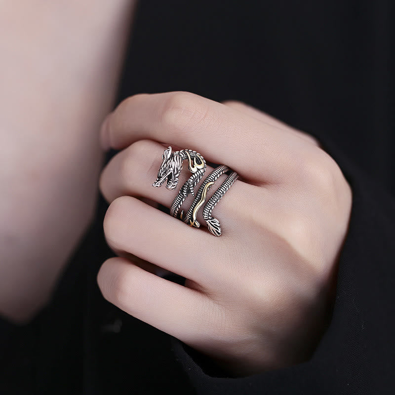 Vintage Dragon Pattern Copper Ring - Dragon ring worn on finger against black, striking