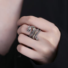 Vintage Dragon Pattern Copper Ring - Dragon ring worn on finger against black, striking
