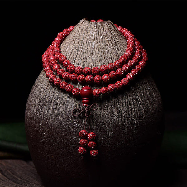 108 Mala Beads Cinnabar Bracelet – Draped on ceramic vase, red prayer beads necklace