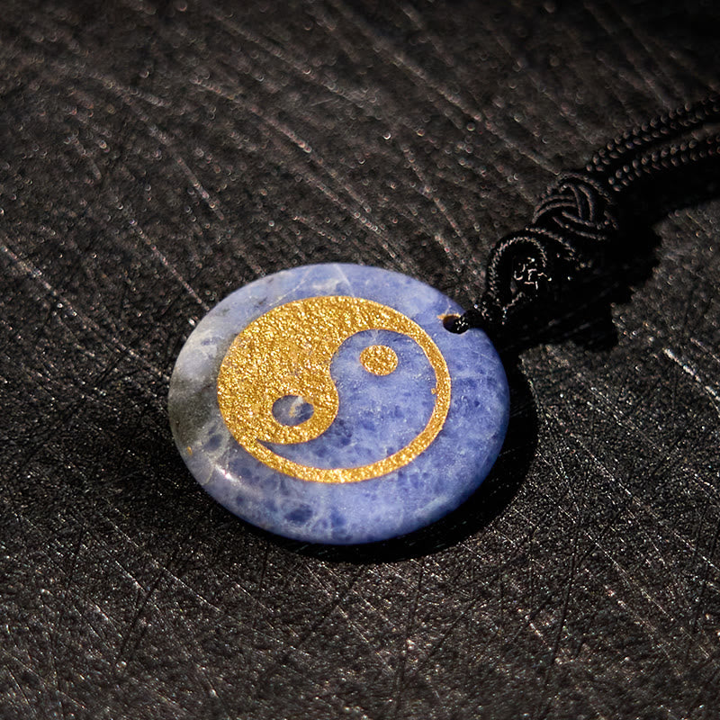 Yin Yang Crystal Necklace – Cream jade round pendant with gold yin-yang symbol, off-white polished stone with natural brownis