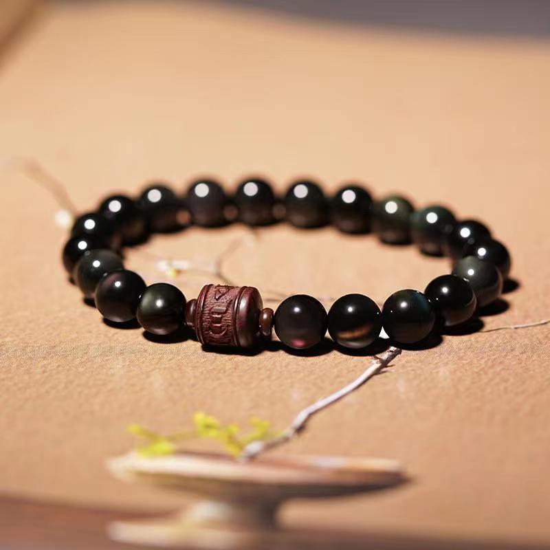 Gold Sheen & Rainbow Obsidian Fu Bracelet – on beige surface with dried flowers, spiritual jewelry