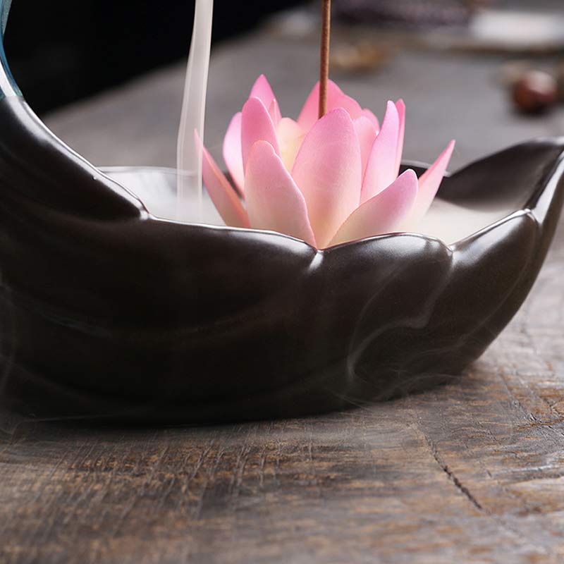 Little Deer Ceramic Lotus Incense Burner – Pink lotus flower in dark ceramic basin with smoke cascade on aged wood