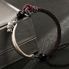 Dragon Braided Bracelet – red satin table runner with gold scrollwork and tassel detail, traditional textile