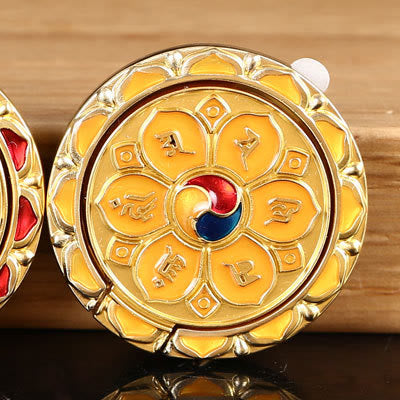 Om Mani Padme Hum Phone Ring Holder – Gold Buddhist medallion with yellow lotus and taegeuk, prayer wheel