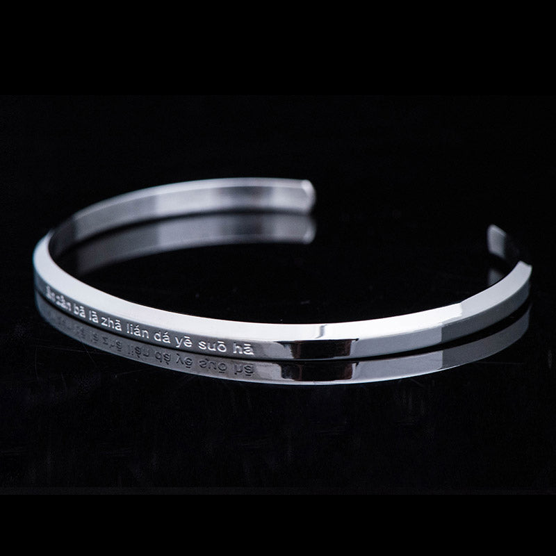 Om Mani Padme Hum Engraved Bracelet – silver cuff at low angle with Buddhist mantra, steel bangle