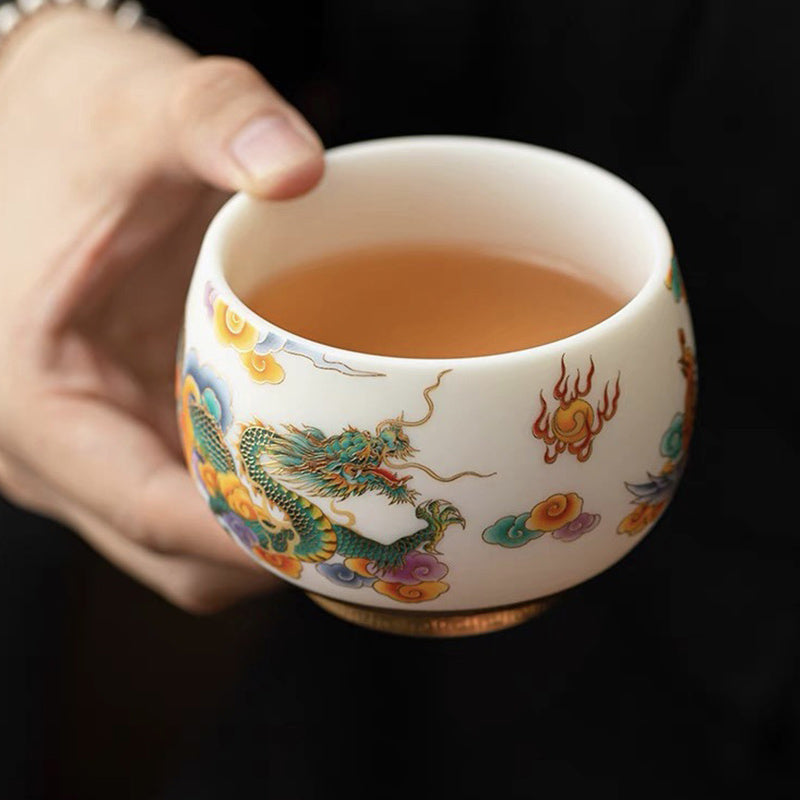 Dragon Phoenix Clouds Ceramic Teacup - Green dragon with amber clouds held against black, ceremonial
