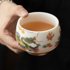 Dragon Phoenix Clouds Ceramic Teacup - Green dragon with amber clouds held against black, ceremonial