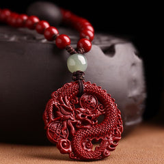 Cinnabar Hetian Jade Dragon Necklace - cinnabar dragon pendant close-up with jade bead accent
