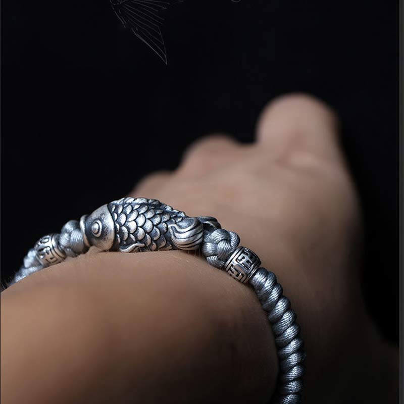 999 Silver Koi Fish Red String Bracelet – top down flat lay, red and silver color contrast jewelry