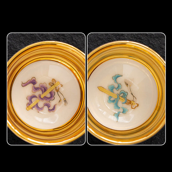 Golden Eagle Dragon Gilt Ceramic Teacup – pair of gold-rimmed decorative medallions with enamel sword and ribbon motifs, ornamental