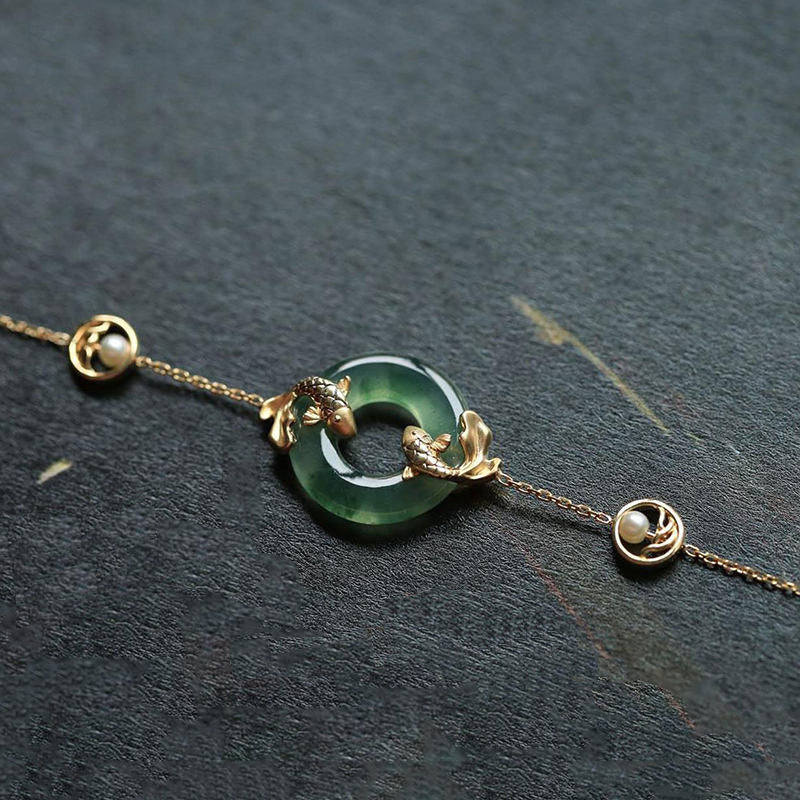 Cyan Jade Koi Fish Bracelet - lifestyle shot with natural lighting, meditation accessory