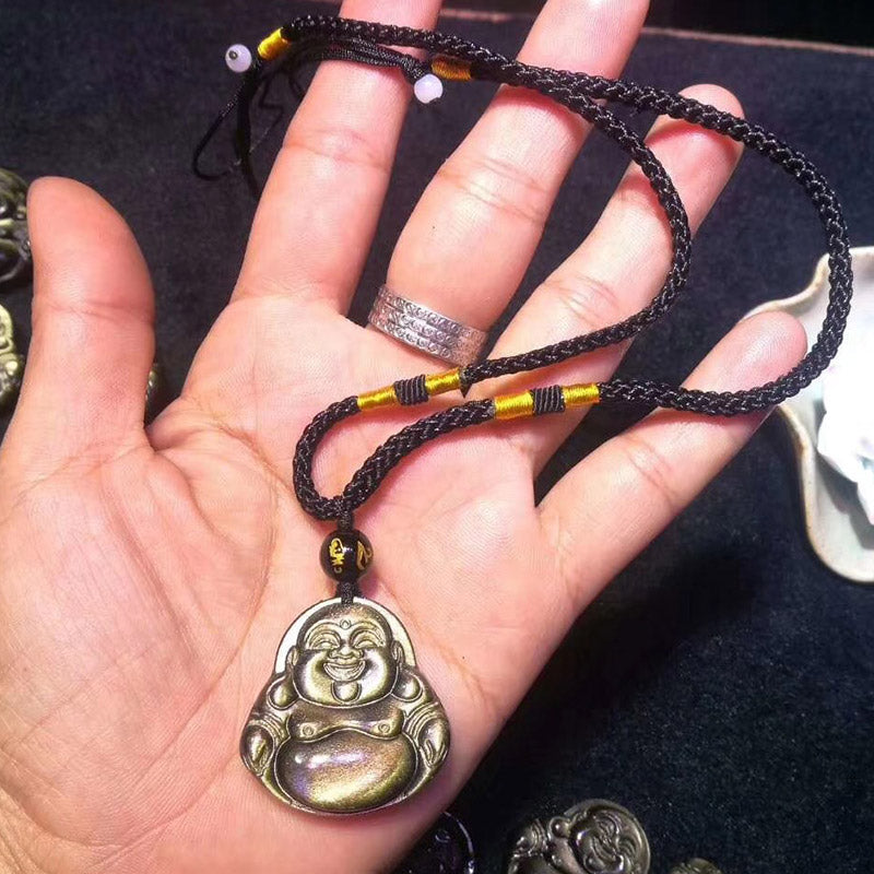 Gold Sheen Obsidian Laughing Buddha Pendant – hand holding pendant showing size with braided cord, scale