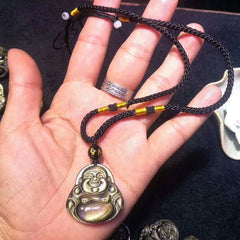 Gold Sheen Obsidian Laughing Buddha Pendant – hand holding pendant showing size with braided cord, scale