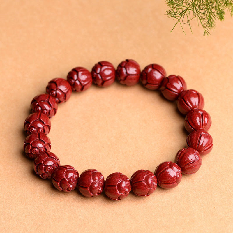 Cinnabar Om Mani Padme Hum Bracelet – lotus carved burgundy beads three-quarter view, flower bead bracelet