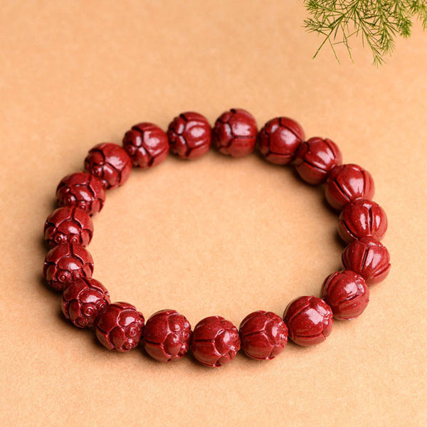 Cinnabar Om Mani Padme Hum Bracelet – lotus carved burgundy beads three-quarter view, flower bead bracelet