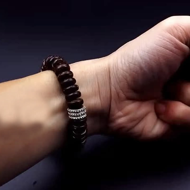 Om Mani Padme Hum Coconut Shell Bracelet – worn side view on wrist, silver ring detail