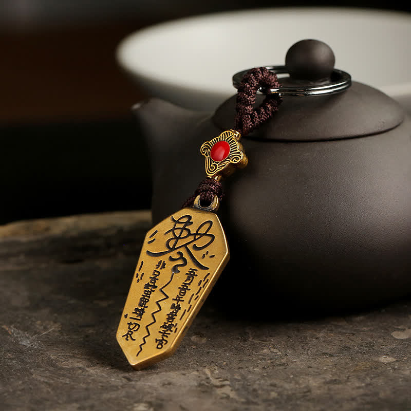 Feng Shui Bagua & Yin Yang Copper Keychain - Pendant with red stone center and beaded dangles on light bg, talisman keychain