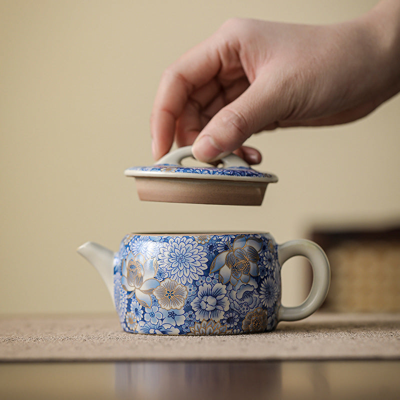 Lotus Chrysanthemum Ceramic Teapot - Side view with lid ajar revealing unglazed rim, handmade