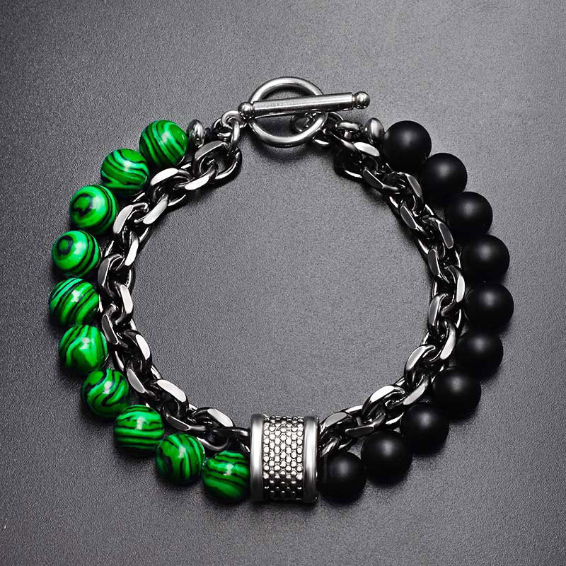 Tiger Eye Lazurite Malachite Protection Bracelet – Flat-lay of men's bracelet with green malachite-patterned and matte black beads, silver curb chain, textured barrel spacer, and toggle clasp