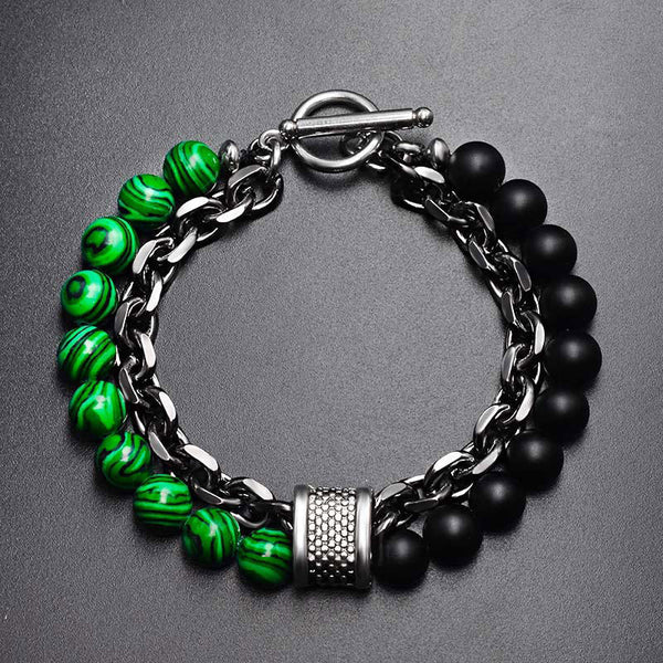 Tiger Eye Lazurite Malachite Protection Bracelet – Flat-lay of men's bracelet with green malachite-patterned and matte black beads, silver curb chain, textured barrel spacer, and toggle clasp