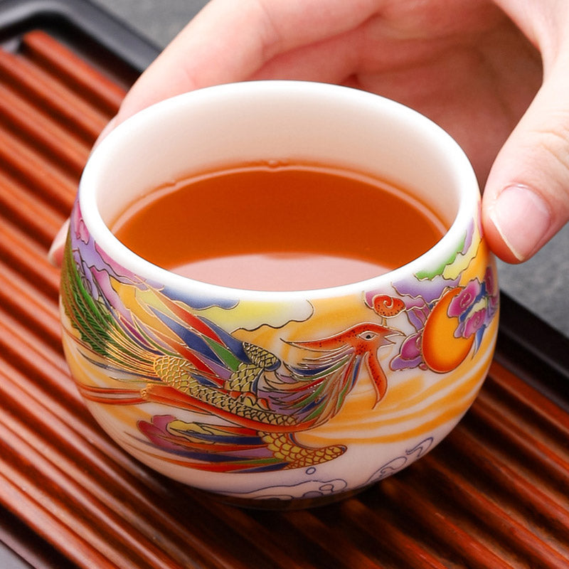Dragon Phoenix Ceramic Teacup - Phoenix teacup held over bamboo tea tray, ceremonial
