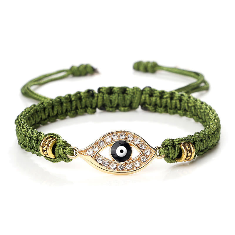 Olive green cord evil eye bracelet with gold crystal pave charm on white background