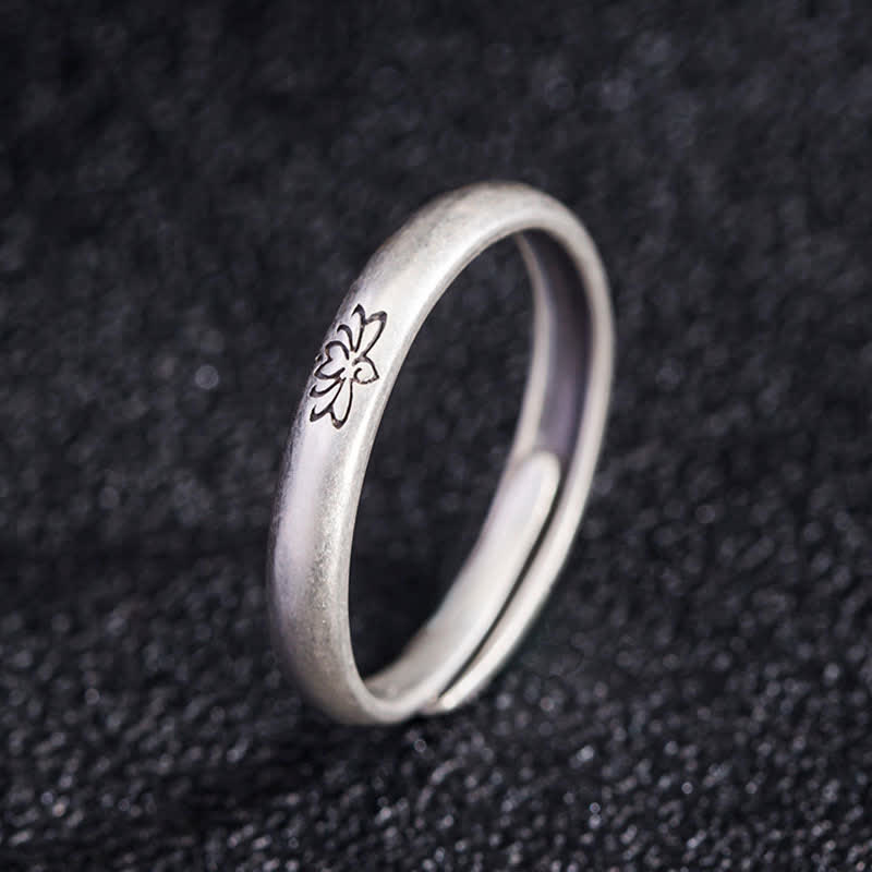 Lotus Enlightenment Ring - adjustable open band with engraved flower on dark fabric, 925 silver