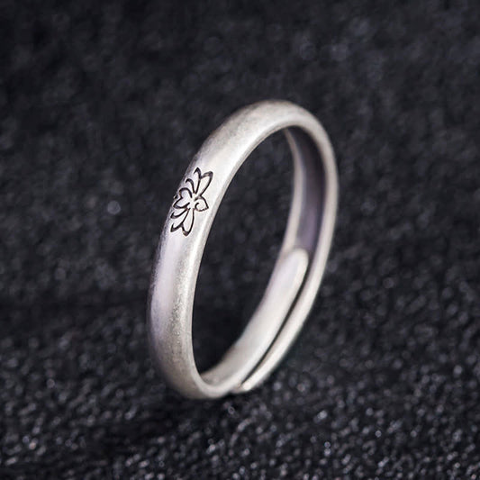 Lotus Enlightenment Ring - adjustable open band with engraved flower on dark fabric, 925 silver