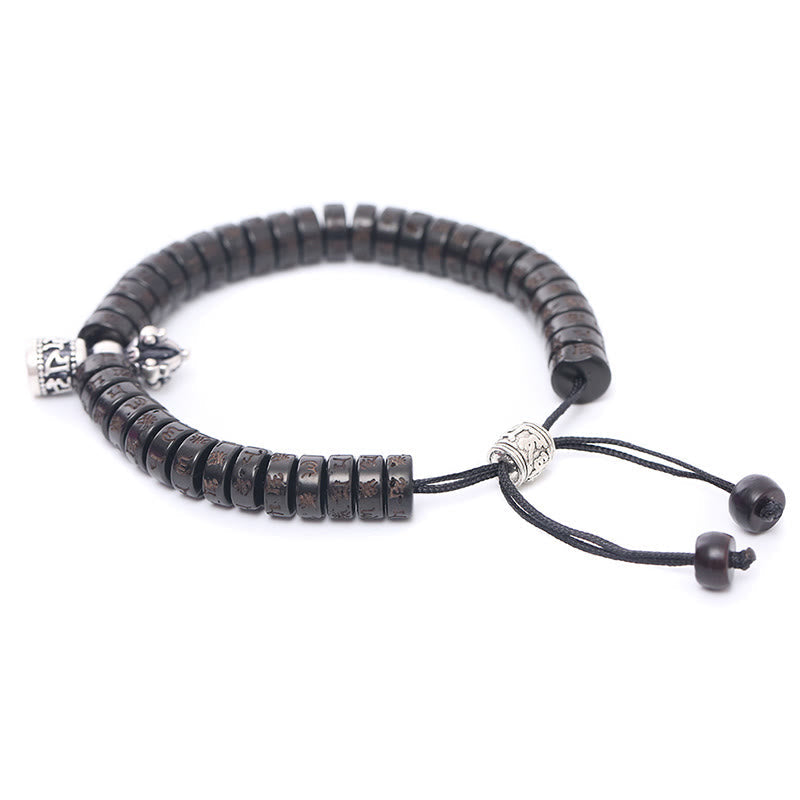 Coconut Shell Dorje Vajra Bracelet – Three-quarter angle showing dark disc beads with silver-toned engraved accents, adjus...