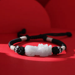 Natural Jade PiXiu Bracelet – white jade beast on black cord silver knots, red backdrop, jade prosperity luck
