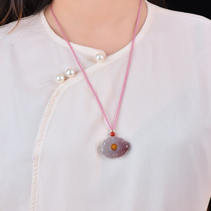 Jade Lotus Pendant – Purple carved lotus necklace worn on white blouse, amber center detail, elegant ethnic style