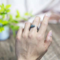 925 Sterling Silver Dragon Ring – Ring on hand against blurred green plant and indoor background, Wearable