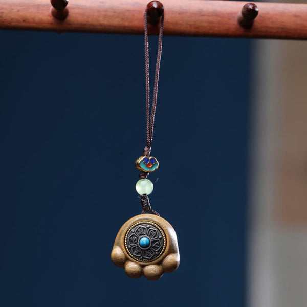 Sandalwood Om Mani Padme Hum Lucky Cat Paw Phone Charm - Golden-brown paw with turquoise inlay