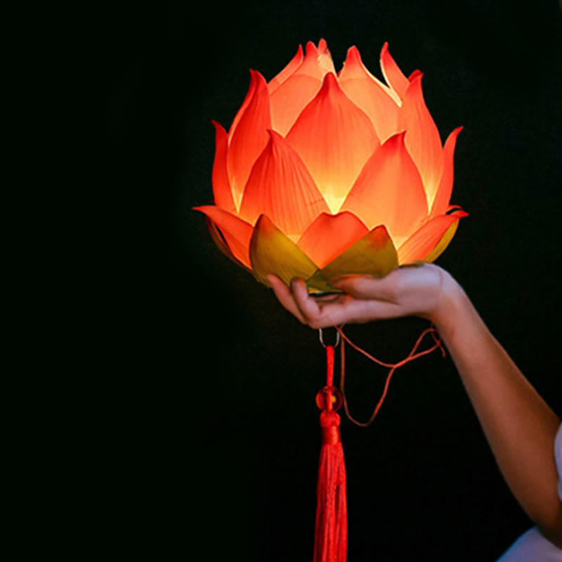 DIY Lotus Dragon Lantern Tassel Lamp – Warm orange-red lotus lantern cradled by hand against black, Radiant glow