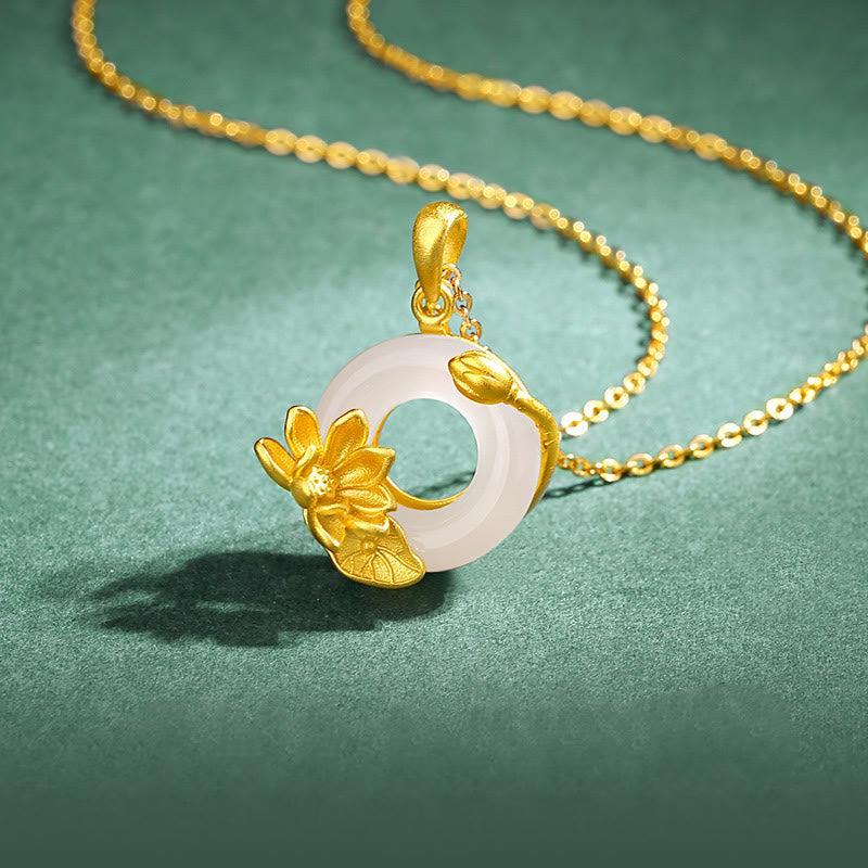 White Chalcedony Lotus S925 Necklace - angled view on green, gold lotus on jade disc